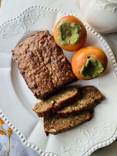 a white plate topped with sliced bread and fruit