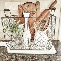 kitchen utensils in a wire basket on a counter