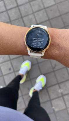 a close up of a person's wrist with a smart watch on the other hand