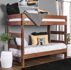 a bunk bed sitting in the middle of a living room next to a rug and potted plant