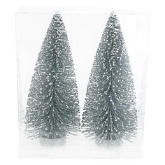 two small christmas trees in a clear plastic box on a white background with snow flakes