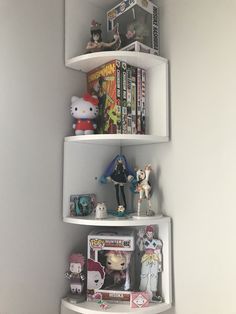 three white shelves filled with toys and books