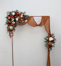 an arch decorated with flowers and greenery for a wedding or reception ceremony is displayed on the wall