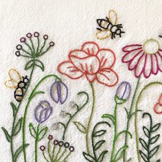 embroidered flowers and bees on a white towel