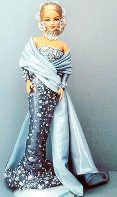 a barbie doll wearing a blue evening gown