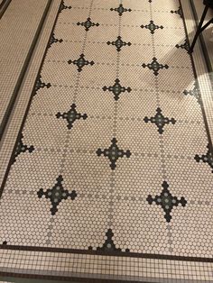 a tiled floor with black and white designs on it