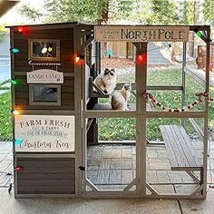 a chicken coop is decorated with christmas lights