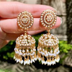 Indulge in the luxury and elegance of our meticulously handcrafted jadau jhumka earrings. The pair features freshwater pearls delicately studded on 925 silver, with 22k gold plating that exudes sophistication. Elevate your style with our unique and exclusive jewelry, designed for those with discerning tastes. Luxury Pearl Drop Chandbalis For Festive Occasions, Jadau Jhumka, 22k Gold Jewelry Necklaces, 22k Gold Jewelry, Buy Pearls, Pearl Necklace Set, Gold Jewelry Necklace, Emerald Necklace, Jhumka Earrings