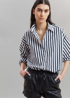 Sylvia Striped Oxford Shirt - Faded Black/White Shirt The Frankie Shop Trendy Shirt With Shirttail Hem For Daywear, Oversized Blouse With Roll-up Sleeves And Spread Collar, Oversized Blouse With Placket For Spring, Oversized Spring Blouse With Placket, Classic Shirt With Rolled Sleeves For Day Out, Classic Shirt With Roll-up Sleeves For Day Out, Chic Shirt For Daywear With Relaxed Fit, Oversized Spring Shirt With Cuffed Sleeves, Oversized Spring Shirt With Placket