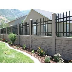 a house with a fence and flowers in the front yard