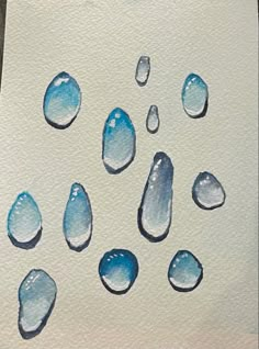 watercolor painting of blue drops on white paper