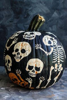 a pumpkin decorated with skulls and bones