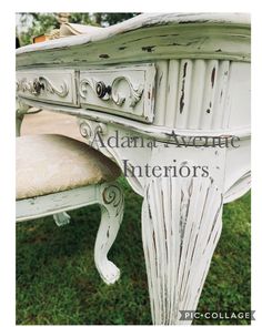 an old white desk with ornate carvings on it's top and bottom edge, sitting in the grass