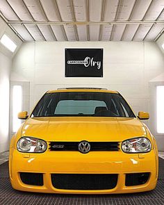 a yellow car is parked in a garage