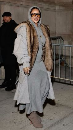 a woman in grey dress and fur coat