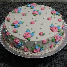 a white cake with pink and blue flowers on it