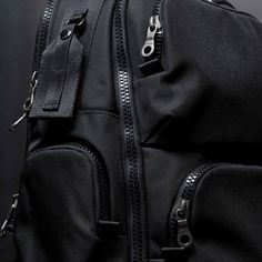 a black backpack with two zippers on it