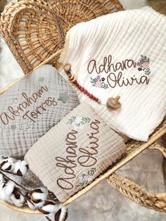 three personalized baby blankets in a wicker basket