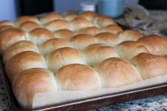 a pan filled with bread sitting on top of a counter