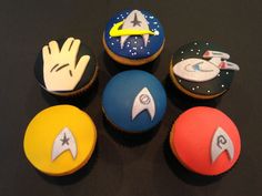 cupcakes decorated with star trek designs on top of each other in different colors