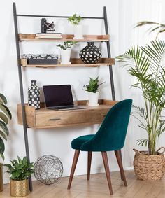 a laptop computer sitting on top of a wooden shelf next to a green chair and potted plant