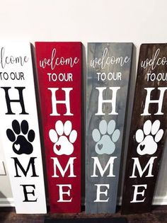 three wooden signs that say welcome, welcome to our home and pet paws on them