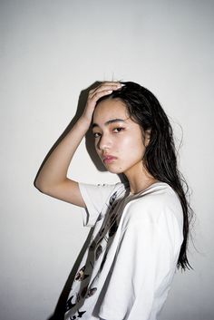 a woman with long hair is posing for the camera