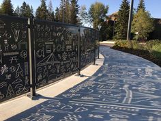 a sidewalk with chalk drawings on it and trees in the backgroung area