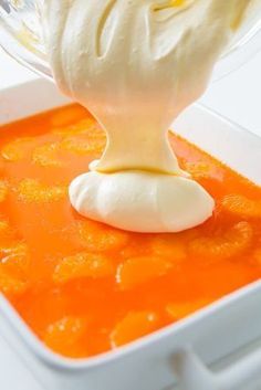 a white bowl filled with carrots and cream