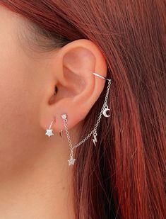 "Look stunning with this CZ stud earring and ear cuff with a delicate chain with charms. It is made of 925 Sterling Silver and 18K Gold plated. It has three charms: a moon, a lightning bolt, and a star with cubic zirconias in pavé setting to give a sparkly look. This earring is only for the left ear. This minimalist and chic earring is a great gift idea. 👉🏼Features: ♥ This earring requires 1 earlobe piercing. ♥ This ear cuff is only for the left ear. ♥ Suitable for sensitive skin. Hypoallergen Party Dangle Ear Cuff With Adjustable Chain, Trendy Pierced Dangle Ear Cuff, Dainty Dangle Single Ear Cuff, Dainty Dangle Ear Cuff, Dainty Single Dangle Ear Cuff, Dainty Silver Cartilage Earrings For Party, Silver Dangle Piercings With Matching Earrings, Sterling Silver Dangle Ear Cuff For Party, Dainty Dangle Sterling Silver Ear Cuff