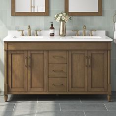 a bathroom vanity with two mirrors above it