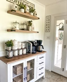 a coffee bar with two shelves above it and some cups on the top, along with other items