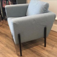 a blue chair sitting on top of a hard wood floor