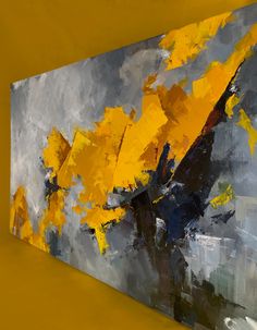 an abstract painting with yellow leaves on it's side, against a gray background