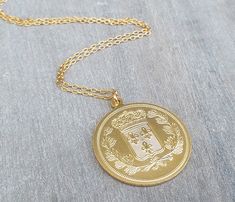 "We have just found your new 'go-to' everyday necklace with our large gold coin necklace. This necklace is so versatile, meaning you can wear it on its own during the day, layered with other pieces for a fun night out, or paired with other gold pieces for an evening-ready look. This necklace has an intricately-designed 14 karat gold plated coin-inspired charm hanging delicately from a 14k gold filled chain necklace. Coin pendant is a two-sided pendant. The oversized coin design is big enough to Gold Medallion Locket Necklace, Gold Coin Necklace With Large Pendant, Gold Medallion Necklace With Large Pendant, Gold Coin Pendant Medallion Necklace, Gold Medallion Necklace With Coin Pendant, Coin Necklace Gold, Necklace Long Gold, Long Necklace Gold, Necklace Gold Pendant