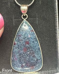 Looking for a way to elevate your jewelry collection? This exquisite pendant featuring Ruby in Kyanite, set in .925 Sterling Silver, is the perfect addition. Its measurements are Length 2", Width 1", Height .25" The Ruby element is believed to stimulate the heart chakra, promoting love, passion, and vitality, while also aiding in the manifestation of one's desires and protecting against negative energies. Ruby In Kyanite, Kyanite Necklace, Heart Chakra, Necklace Pendant, Chakra, Jewelry Collection, Ruby, 925 Sterling Silver, Pendant Necklace