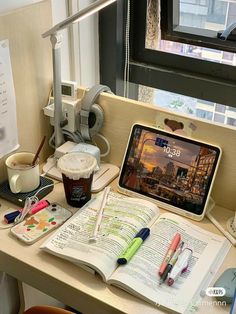 an open book sitting on top of a wooden desk