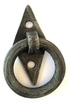 an old metal object with two rings on it's side and a triangle in the middle