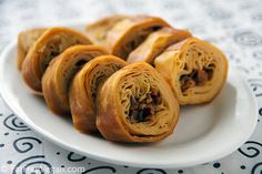 some food is on a white plate and sits on a tablecloth with black designs