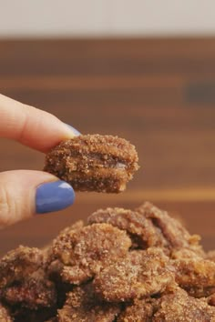 a person is holding some food in their hand and it looks like they are eating something