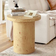 a living room with a couch, table and books on top of the coffee table