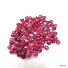 some very pretty pink beads on a white surface