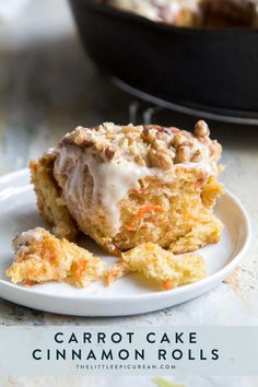 carrot cake cinnamon rolls with icing on a plate