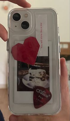 someone holding up their cell phone case with an image of a cupcake and heart on it