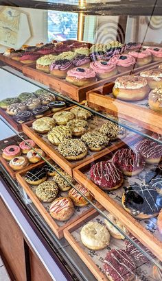 a display case filled with lots of different types of doughnuts and pastries