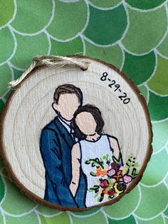 a wooden ornament with an image of a bride and groom holding each other