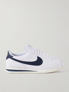 Nike won a debut gold with its 'Cortez' sneakers at the 1972 Olympics, so it's fitting the brand releases a fresh version in time for this year's games. Made from leather in a blue and white colorway, they feature the signature 'Swoosh' and logo heel tab accented with gold lettering. The mesh lining ensures breathablity. Net A Porter Sneakers, Nike Retro Leather Sneakers, Retro Nike Leather Sneakers, Classic Nike Custom Sneakers With Gum Sole, Nike Custom Sneakers With Perforated Toe Box, Classic Nike Custom Sneakers With Perforated Toe Box, Nike Classic Leather High-top Sneakers, Nike Cortez White, Cortez Sneakers