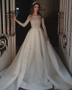 a woman in a white wedding dress is standing outside the door with her hands on her hips