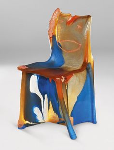 a colorful chair sitting on top of a white table