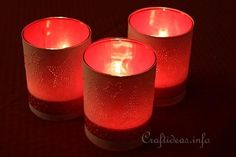 three red candles sitting on top of a table